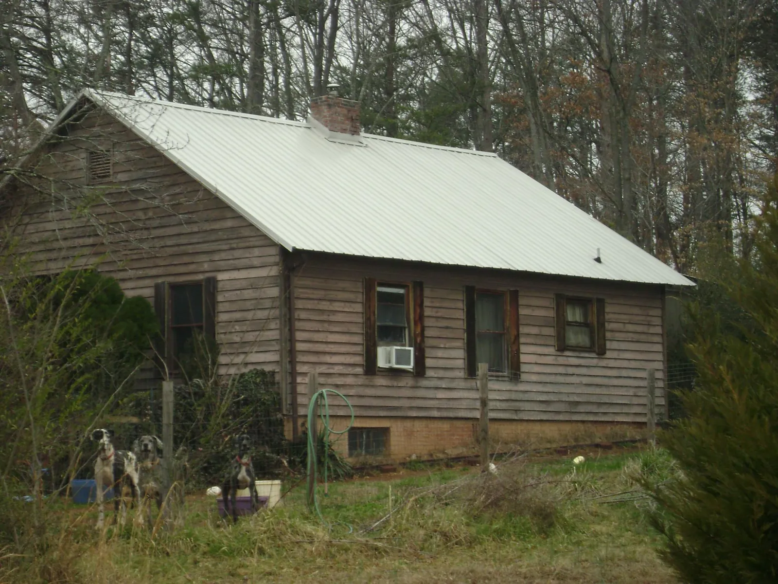 White metal roof on an old wood sided farmhouse, from a Metal Roof Installation job in Momence